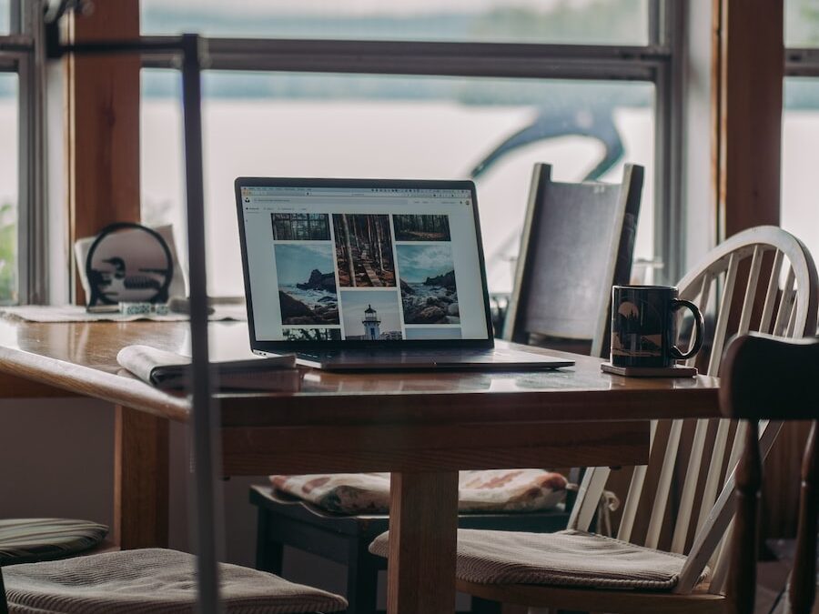 black laptop computer on brown wooden table